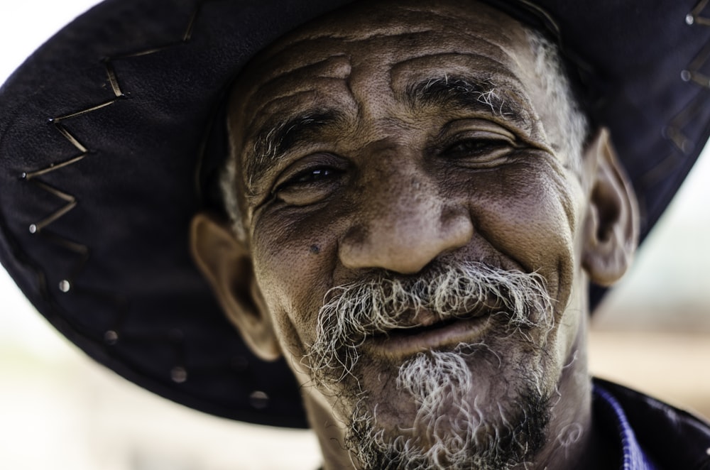 closeup photography of man wearing black hat