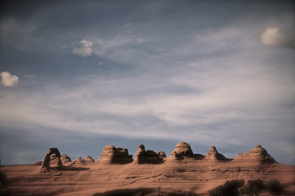 brown rocky mountain under white clouds