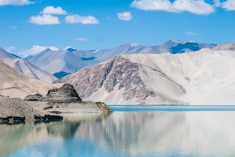 landscape photography of snow covered mountain near body of water