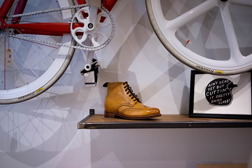 unpaired brown leather wingtip shoe on floating shelf