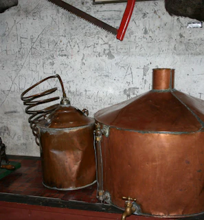 Copper stills gleaming in a traditional distillery setting