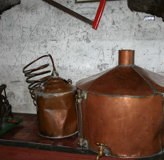 Copper stills gleaming in a traditional distillery setting