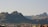 brown mountain with houses during daytime
