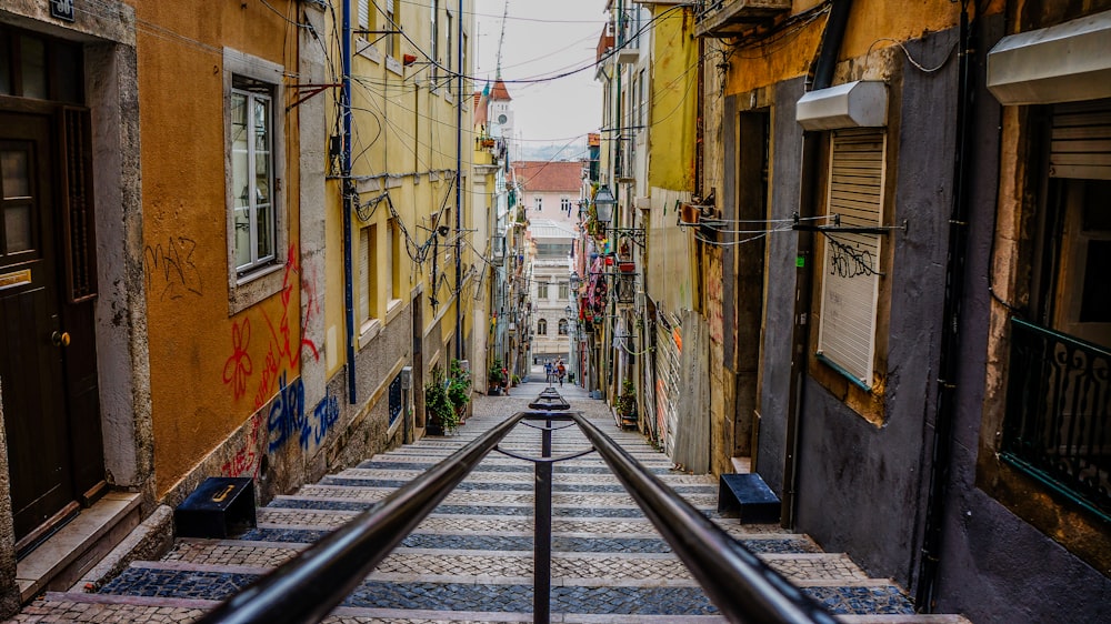 stairs in between colorful buildings