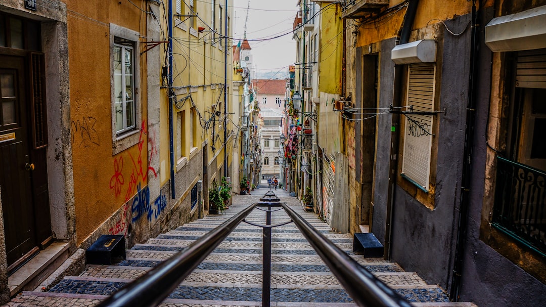 stairs in between colorful buildings, Lisbon alley staircase