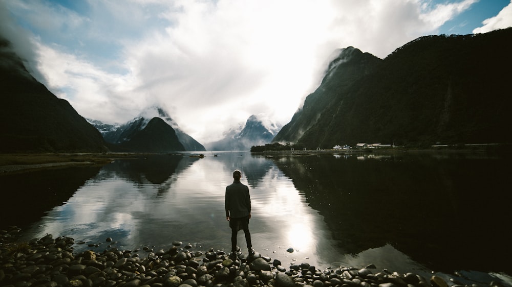 person standing in front of body of water