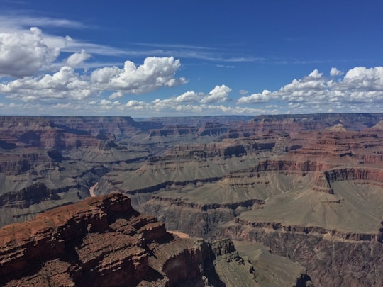 aerial photo of brown and grey mountains under blue cloudy sky photo taken during daytime in Grand Canyon National Park United States