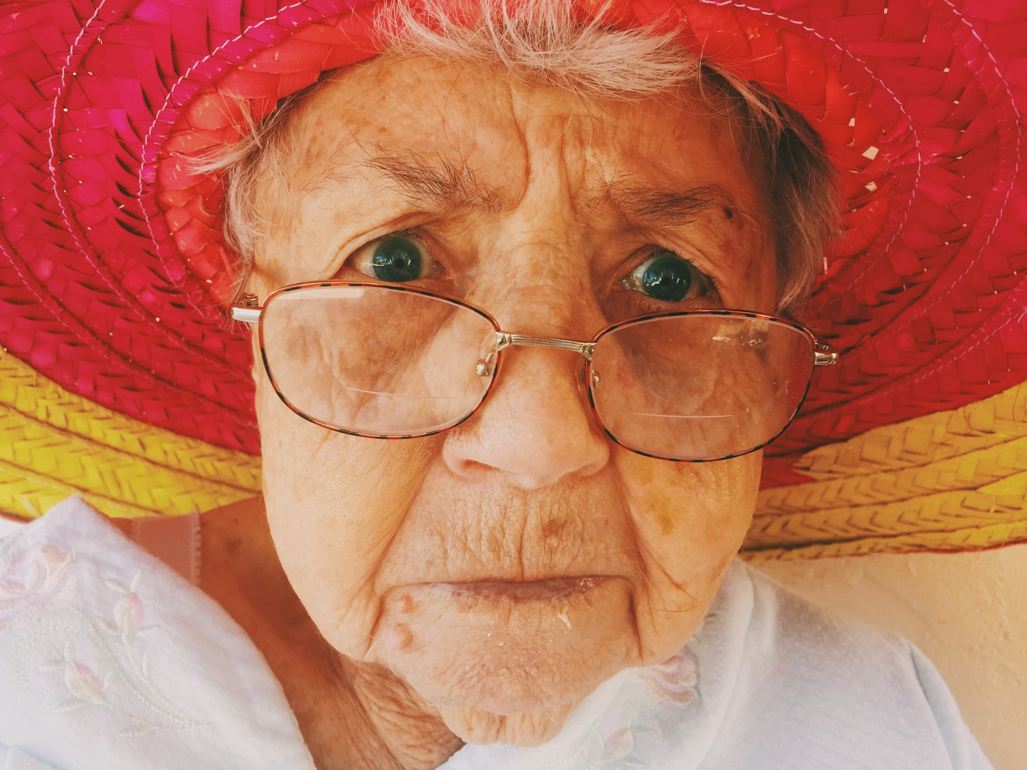 Even when you’re closing in on 100 years old, the experiences when you were young stay with you. My great grandmother is from western Ukraine, went through WWII, and saw a lot. Yet, amazingly, her fierce spirit shows through and mixes with her love for comedy. For this spontaneous shot, I found my Cinco de Mayo hat and plopped it on her. What makes the picture, though, is the life in her eyes and face. Be awake to your experiences.
- with love, Alex