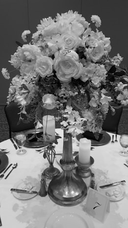 A beautifully arranged floral centerpiece on a table set for a celebration.