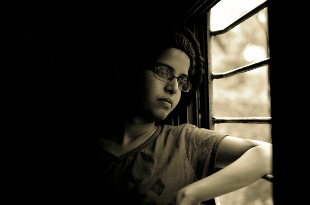 woman looking out through window