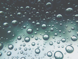 A cinematic shot of floating spheres casting soft neon glows and subtle shadows on a blurred glass surface.