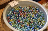 Various sizes of colorful balls and marbles displayed