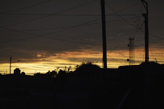 A sleek AI-generated visualization of electromagnetic waves interacting with urban telecommunication towers at dusk.