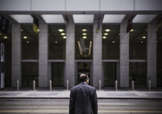 man standing in front of building