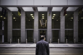 man standing in front of building