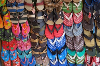 A variety of flip-flops arranged in a colorful pattern.