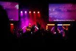 a group of people standing on top of a stage
