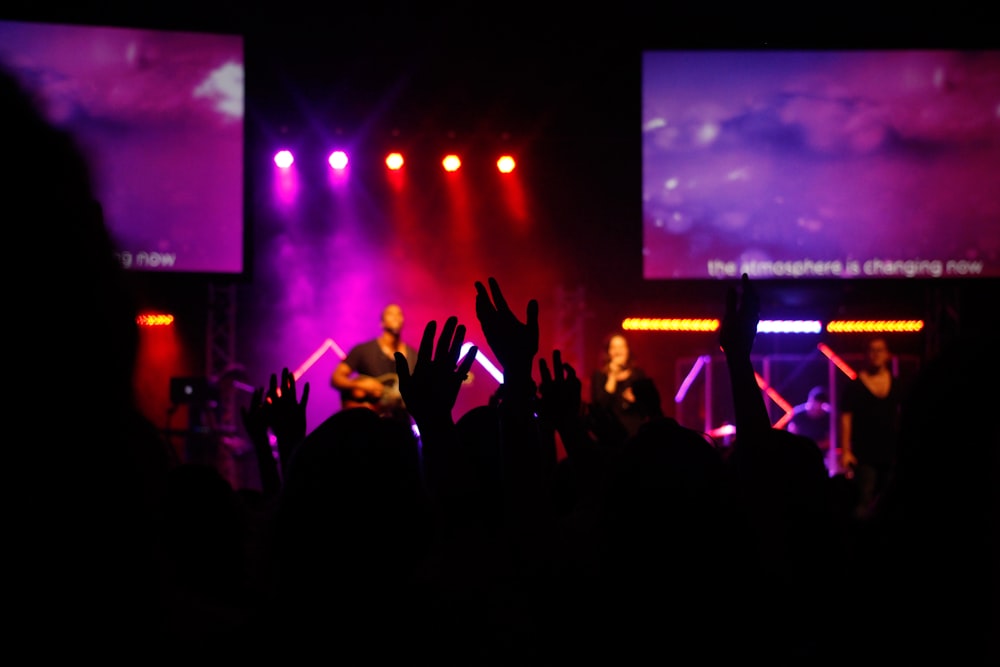 a group of people standing on top of a stage