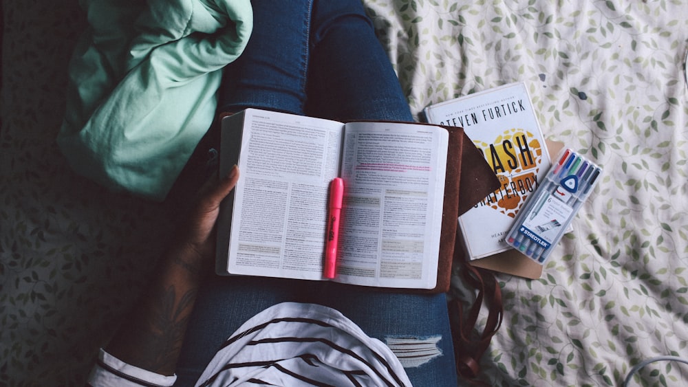 person holding unfold book