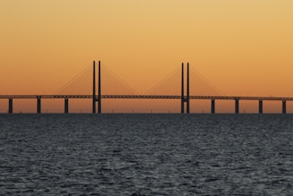 bridge during sunset with body of water