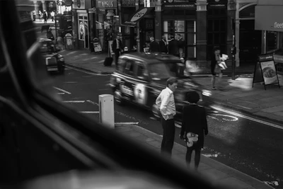 Black and white urban street scene capturing candid movement and emotion.