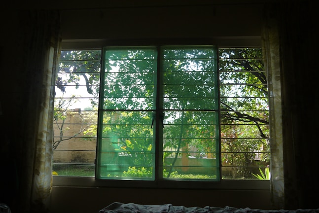Stylish panel curtains framing a large window with a garden view.