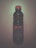 A plastic bottle with a red cap and a label indicating it contains Nestea iced tea with a peach flavor. It is placed upright against a plain background.