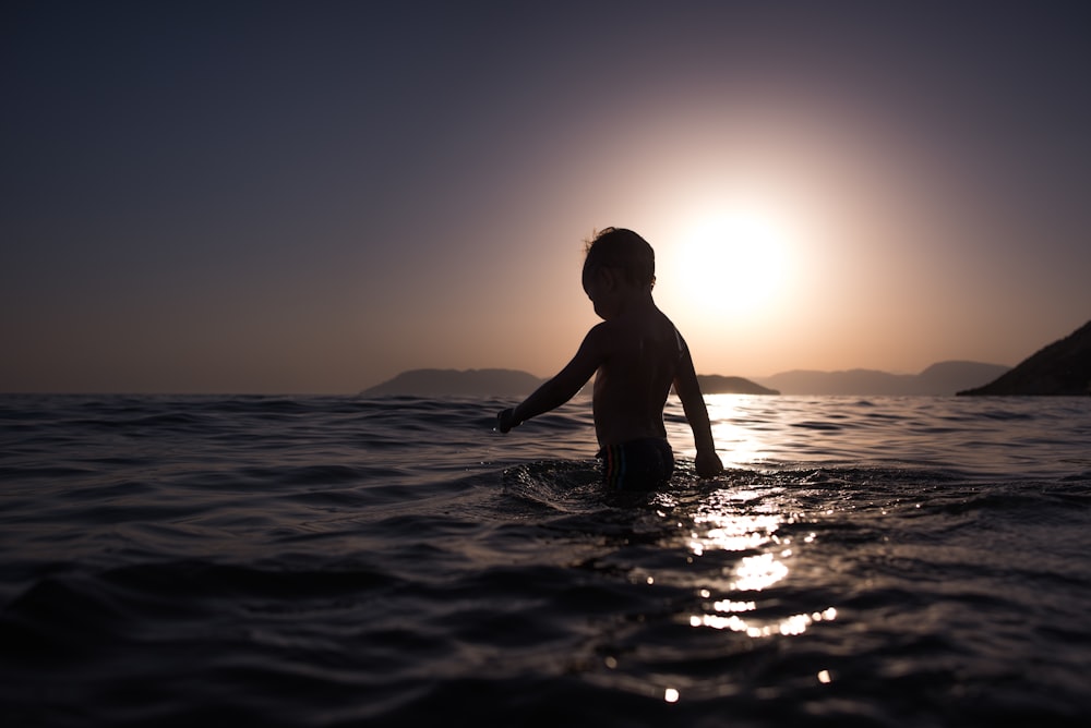 boy standing on body of water