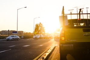 Tow truck assisting a stranded vehicle on a busy city street at dusk