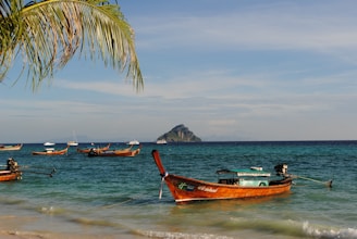 A serene view of the German Channel waters with traditional Palauan canoes floating gently near the shore.