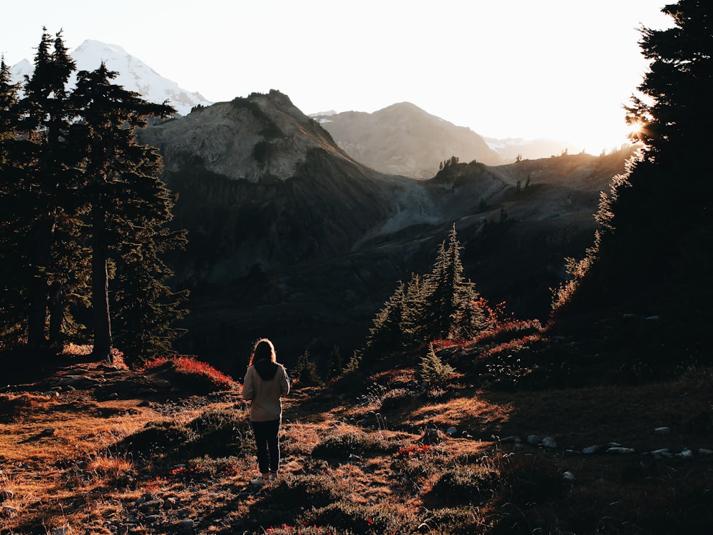 woman standing in front of mountains