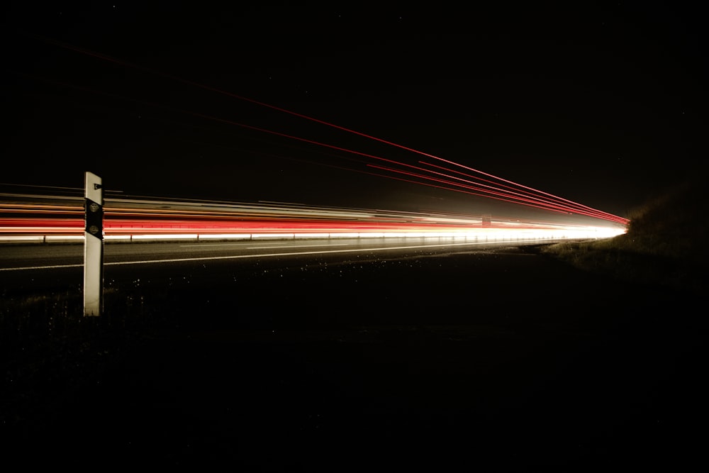 a long exposure photo of a street at night