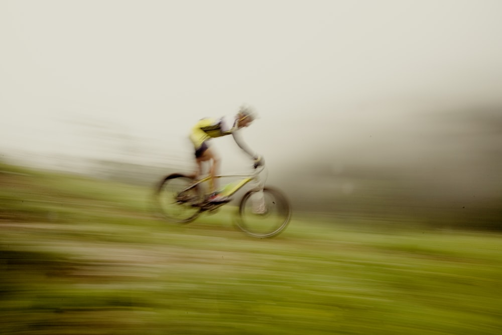 a blurry photo of a person riding a bike