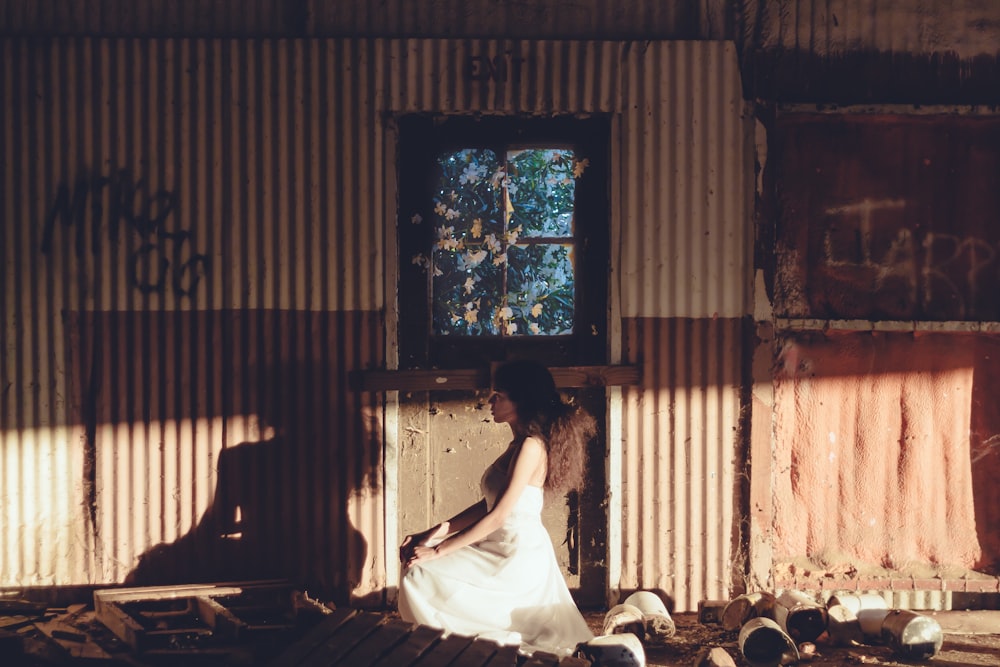 woman sitting near brown door