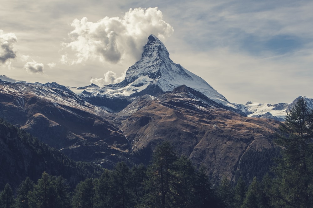 A high snow-covered peak rising above a mountainous landscape