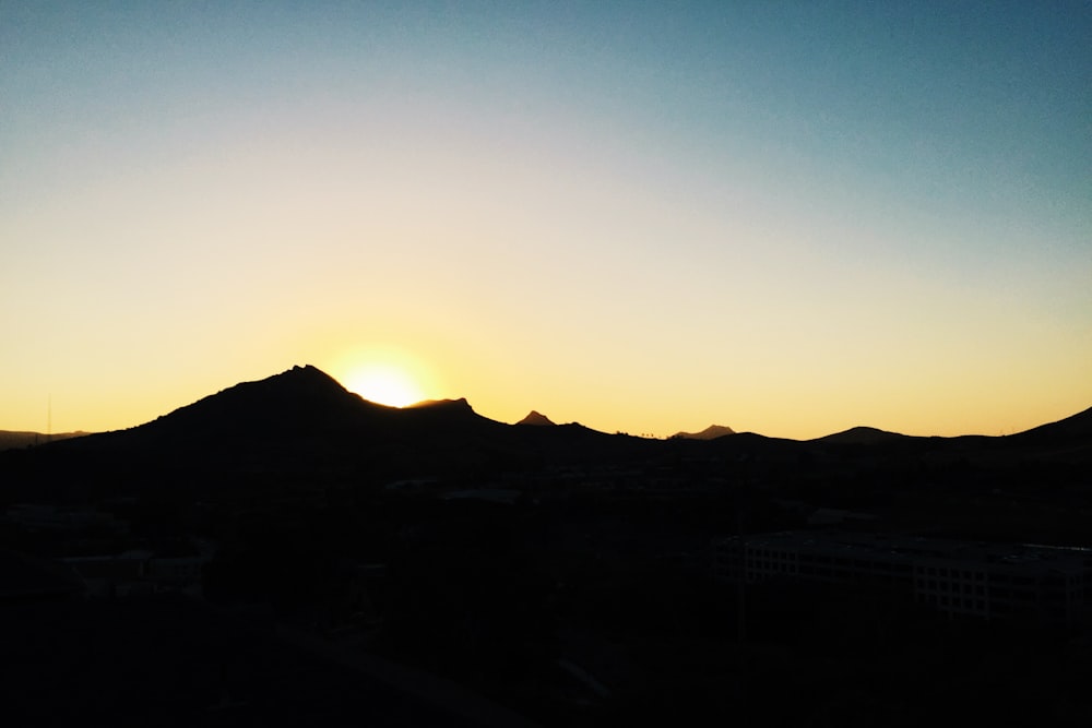 silhouette of mountain during golden hour