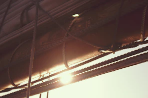 Close-up of ropes and sails bathed in golden light, capturing the texture and warmth of the moment.