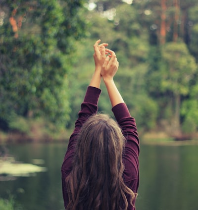 woman raising both of her hands