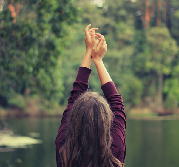 woman raising both of her hands