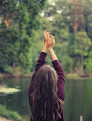 woman raising both of her hands