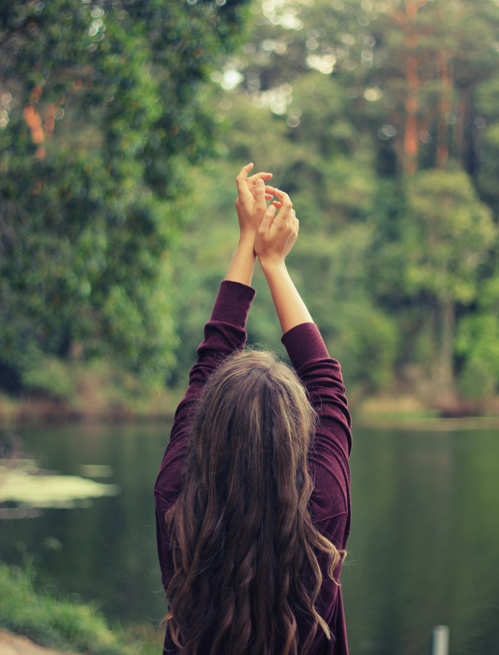 woman raising both of her hands