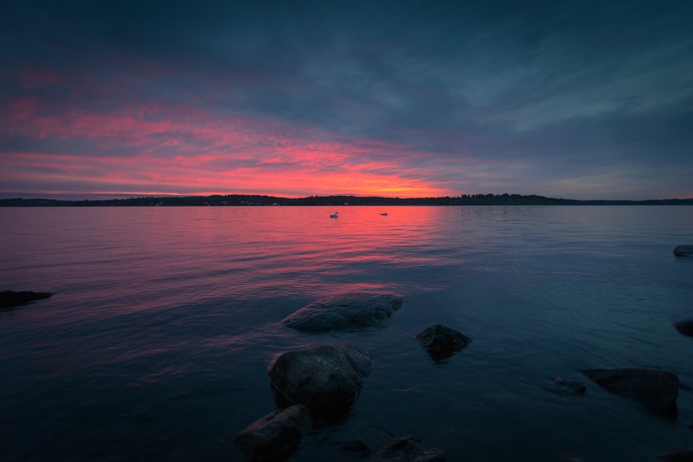 body of water during sunset