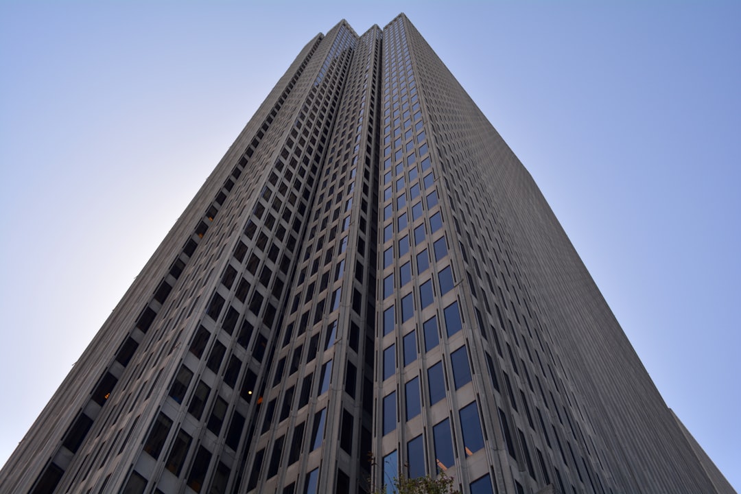 brown high-rise building with clear blue skies