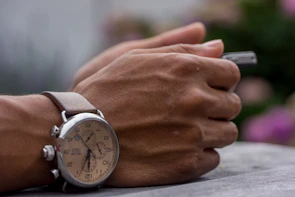 Close-up of hands holding a smartwatch designed for elderly users.