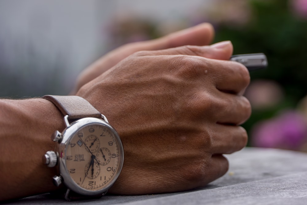 person wearing chronograph watch