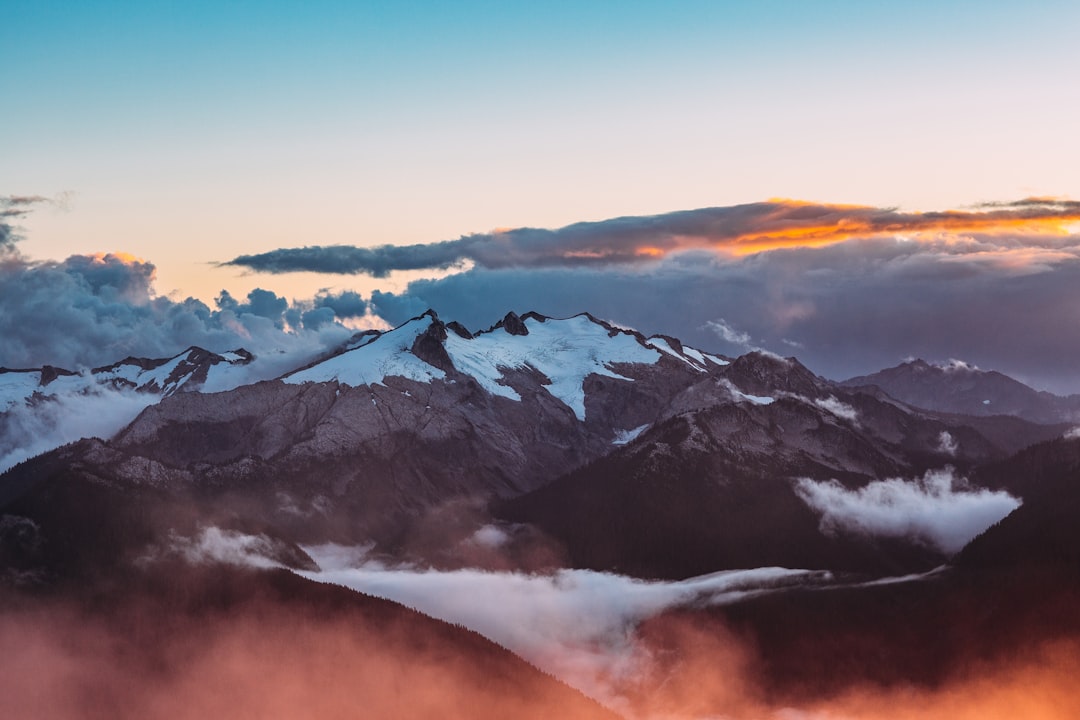 Snow-covered mountains shrouded in mist and clouds