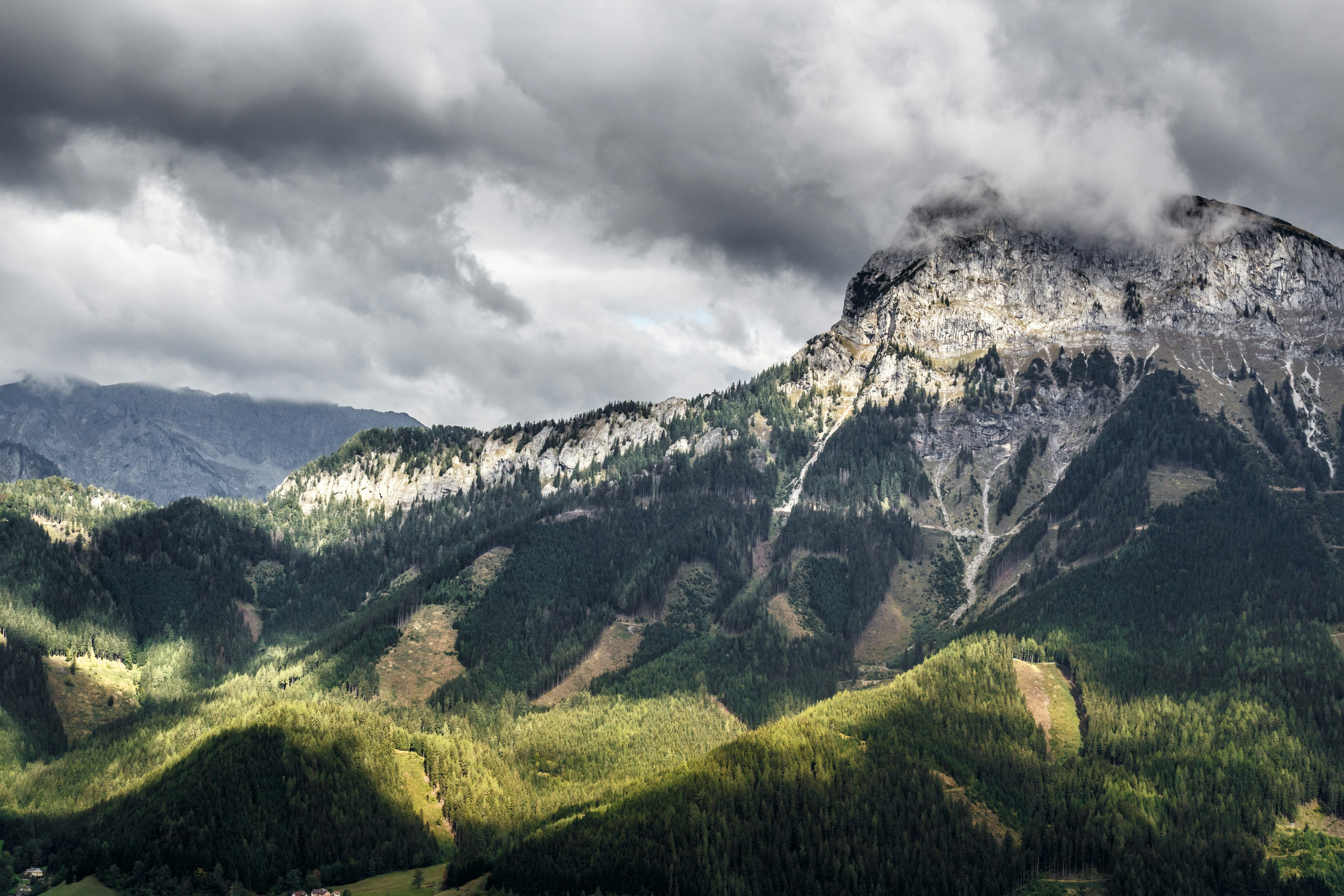 clouds covering peak of mountain