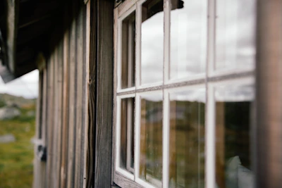 Close-up of a passive house window showcasing triple glazing and natural wood framing.