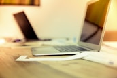 Modern office workspace with laptop and paperwork