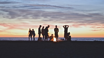 group of people setting up campfire